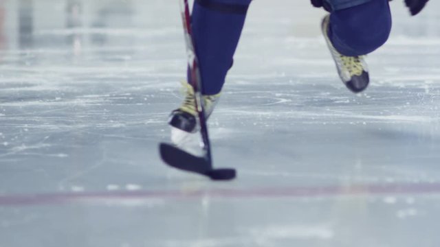 Ice hockey. A hockey player does dribbling. Possession of the puck.