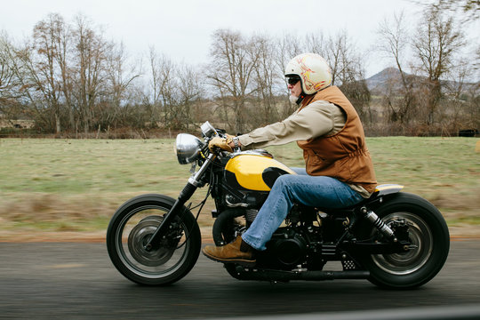 Man Rides motorcycle on road