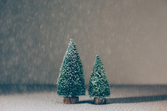 Still life of two Christmas tree with snowflakes.