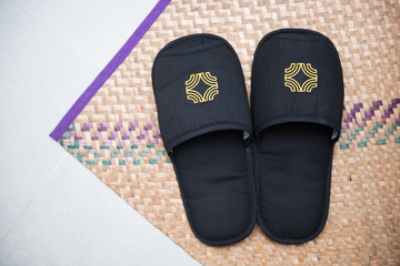 Black slippers on the mat