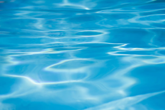 Detail of sunlight on waving swimming pool water