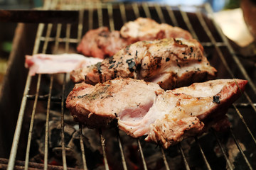 medium roasted pork on iron grill.Thailand local tradition grill pork 