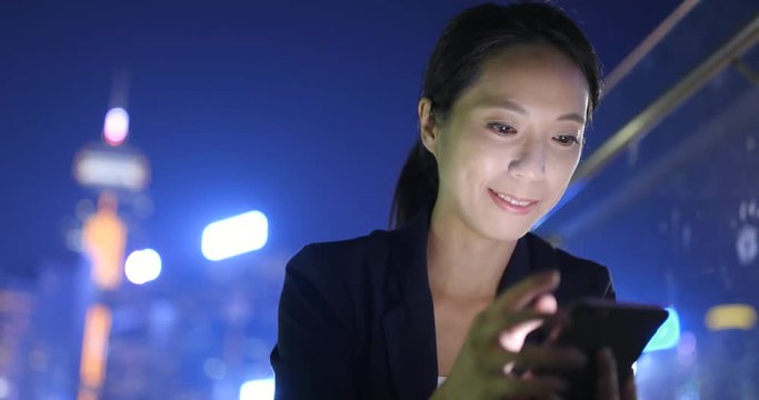 Business woman using smart phone in Hong Kong city