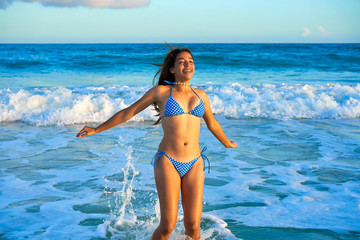 Latin bikini girl jumping in Caribbean beach - obrazy, fototapety, plakaty