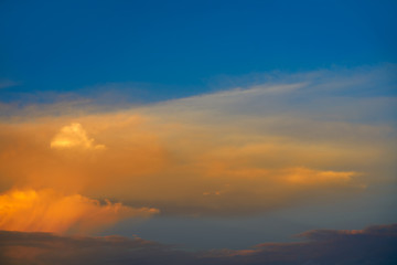 Sunset sky orange clouds on blue