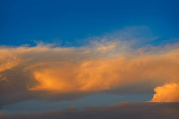 Sunset sky orange clouds on blue