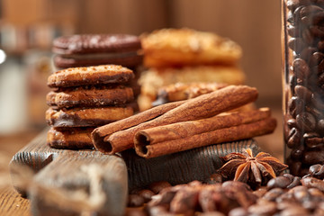 Aroma coffee candy chocolate cookies and spices on the wooden table. Christmas sweets. Dark wooden background. Top view. Close. Closeup.