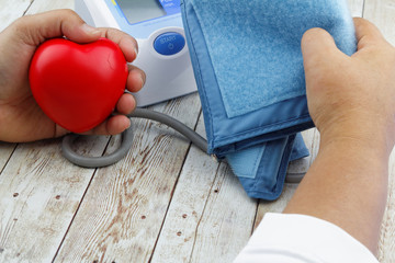 Measuring blood pressure using automatic electronic blood pressure monitor meter. Health care...