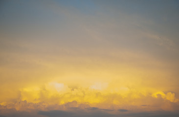 The sky is painted in bright yellow-orange shades.