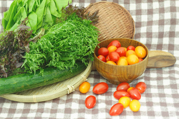 Red and green lollo lettuce,butterhead lettuce,japan cucumber,honey cherry tomatoes on kitchen table
