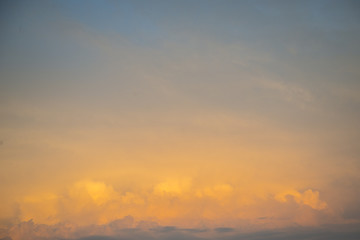 The sky is painted in bright yellow-orange shades.