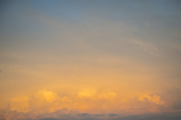 The sky is painted in bright yellow-orange shades.