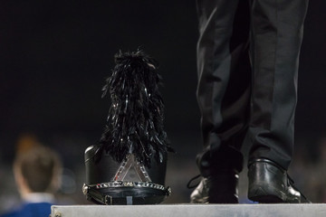 Shako at the feet of drum major in marching band