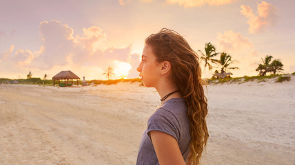 Girl at sunset caribbean beach in Mexico