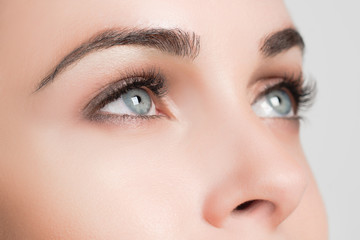 Naklejka premium closeup staring female blue eyes with long lashes