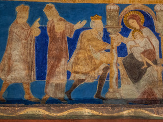 The holy kings bring their gifts to the Christ child.