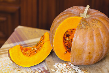 beautiful piece of ripe pumpkin is next to round pumpkin