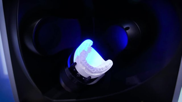 Dental prosthetic restoration. Denturist is making 3D model for sculpted plastic denture with high tech digital scanning equipment. 3d tooth scanning
