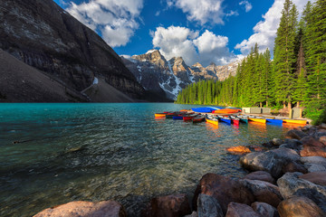 Beautiful Moraine Lake with colorful canoes in Rocky Mountains, Banff National Park, Canada.