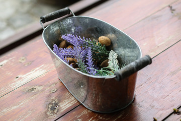 Lavender and nuts in metal basket on wooden table