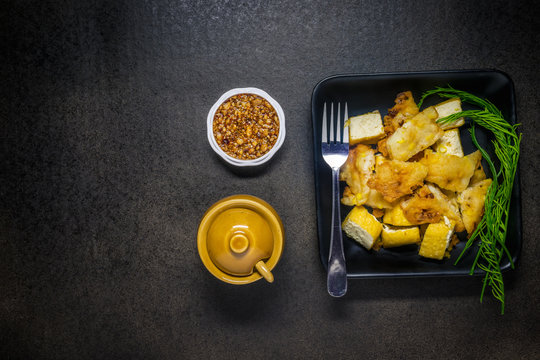 Fried tofu with bean Sauce and vegetable on dark background