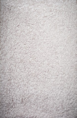 Fototapeta premium Beige wool sheepskin texture background. Top view. Copy space.