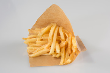 French fries in carton in kraft blank paper fry box on white background isolated