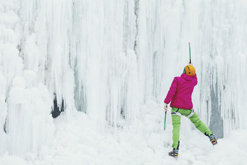 Ice climbing in the mountains along the waterfall.