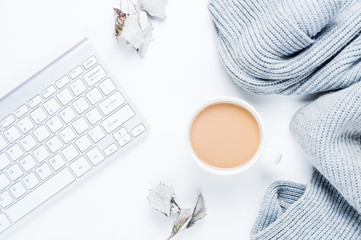 Coffee with milk and a gray scarf on a white background. The concept of beauty blogger
