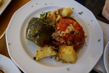 Traditional greek summer dish, baked stuffed vegetables, tomatoes, peppers and roasted potatoes with chopped mint