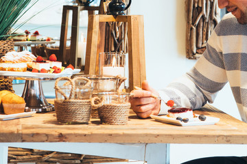 Cropped view of a young man having a piece of cake