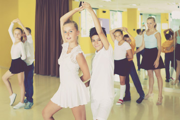 Little boys and girls having dancing class in classroom