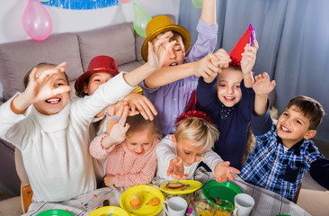 Boys and girls behaving jokingly during friend’s birthday party