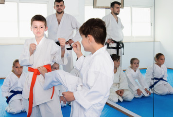 Fototapeta premium Two young boys training in sparring at karate class