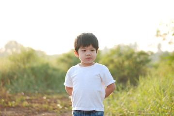 Boy smile happy in the morning, there is a backyard.