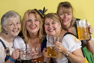Four Women in Dirndls with Mug of Beer in Hand