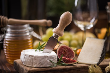 Camembert cheese on board with fig