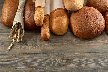 Top view shot of various bread on wooden background copyspace bakery shop store food groceries eating breakfast sandwich pastry baking dough concept.