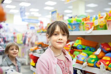 girl in   toy store choosing   toys