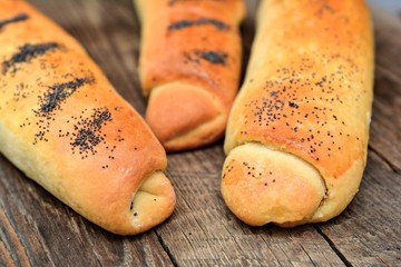 Homemade baking rolls on wooden background