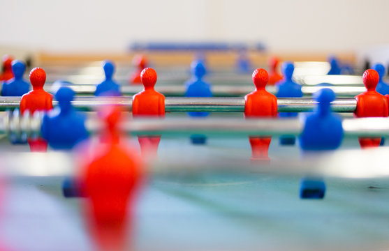 Table football, foosbal red and blue players in macro view