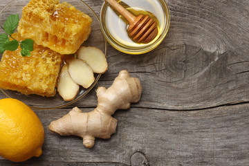 healthy background. honey, honeycomb, lemon, ginger on old wooden table. Top view with copy space
