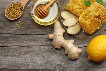 healthy background. honey, honeycomb, lemon, ginger on old wooden table. Top view with copy space