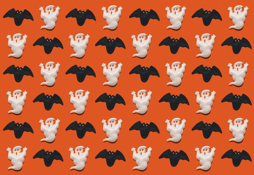 Halloween pattern; black bats and white ghosts on a bright orange background