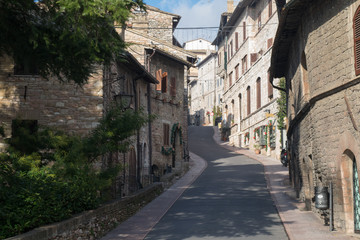 Fototapeta na wymiar Historic buildings line the stone streets of Assisi, Umbria, Italy
