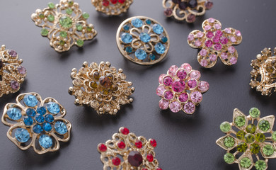 set of brooches isolated on black. background of many brooches