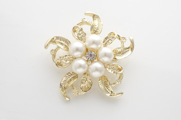 gold brooch flower with pearl isolated on white