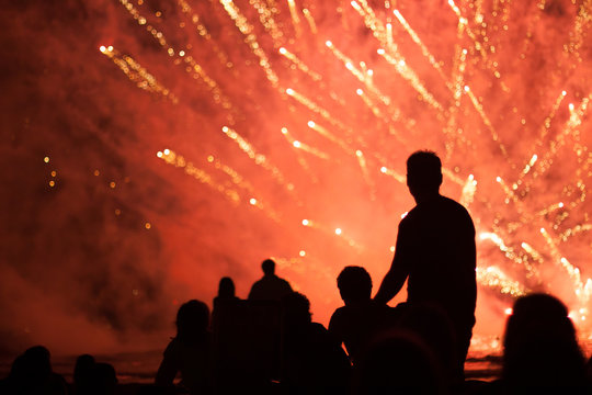 Group of people enjoying fireworks show