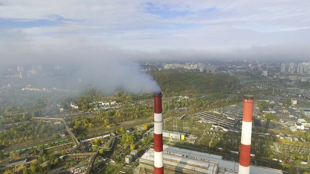 flying over the pipes of the plant from which the smoke goes