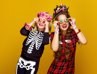 mother and daughter in halloween costume having fun time